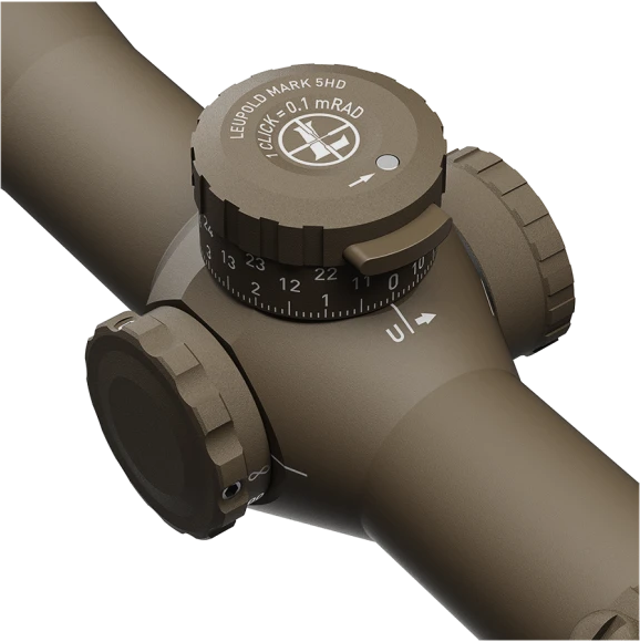 Close-up of a rifle scope with windage/elevation adjustment dials and markings on olive-brown housing as seen from an angled view.