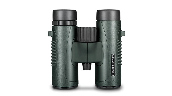 Green binoculars with black eyepieces on a white background, showing the central focusing knob and hinge.