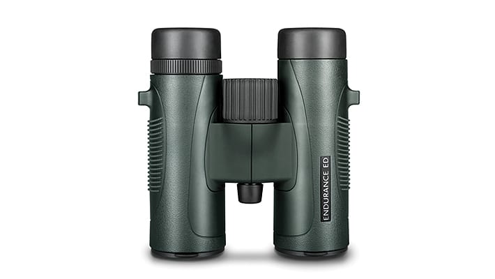 Dark green binoculars with black eyepieces and a central focus wheel on a white background, ready for viewing distant objects.