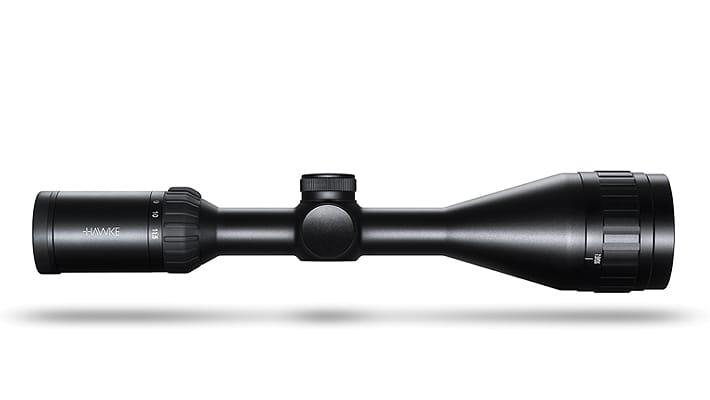 Black rifle scope with adjustable turrets and a lens at each end on a white background, centered profile view.
