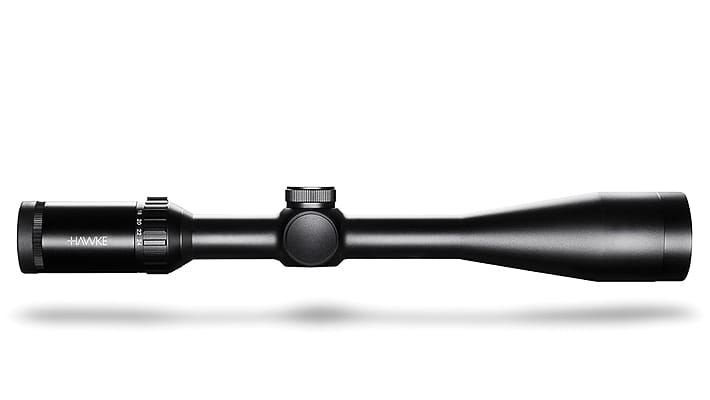 Black rifle scope laid horizontally with adjustable turrets and magnification dial, Hawke brand image for a firearm accessory.