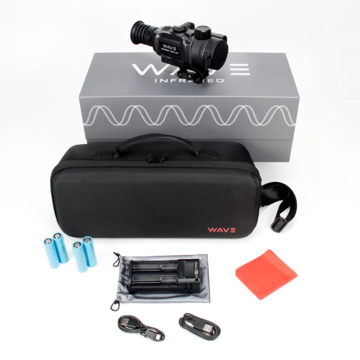 Compact infrared scope kit on a Wave Infrared box, with a black carry case, four blue AA batteries, a charger, red cleaning cloth, and accessories laid out.
