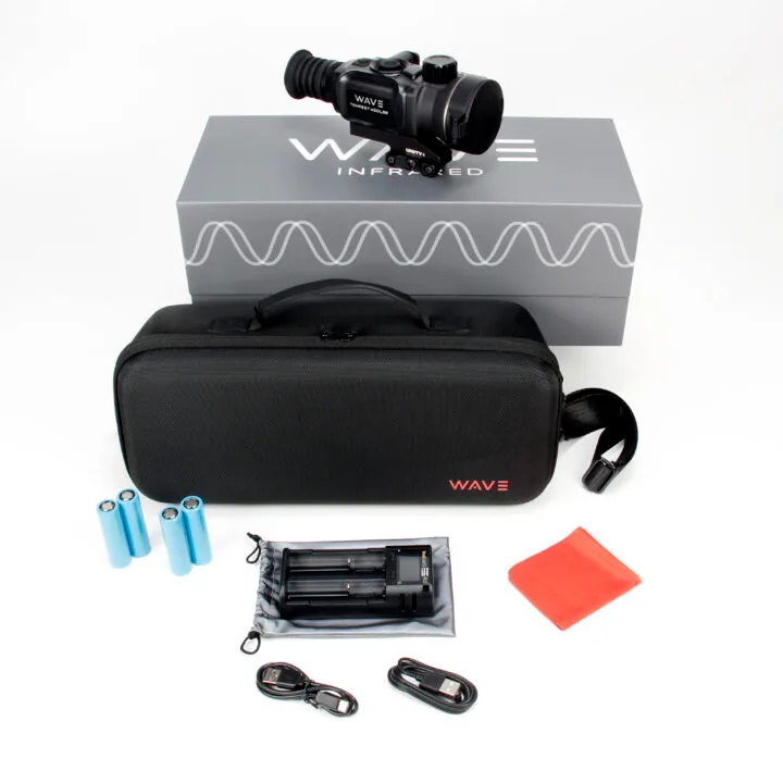 Infrared scope kit: black scope on a gray Wave box with a carrying case, batteries, charger, red cloth, and accessories laid out.