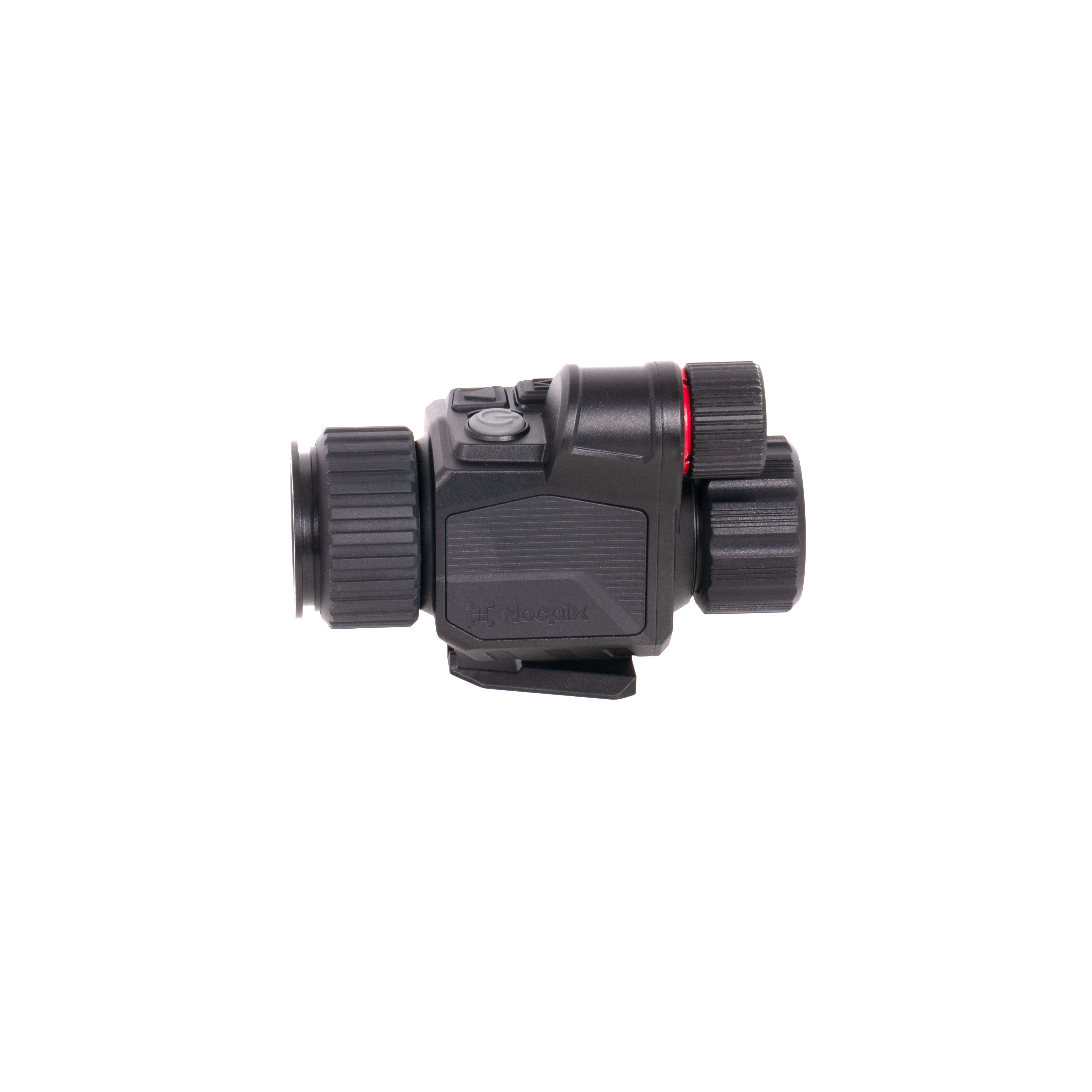 Close-up of a black rifle scope or optic with textured adjustment knobs and a red ring, showing its rugged housing.