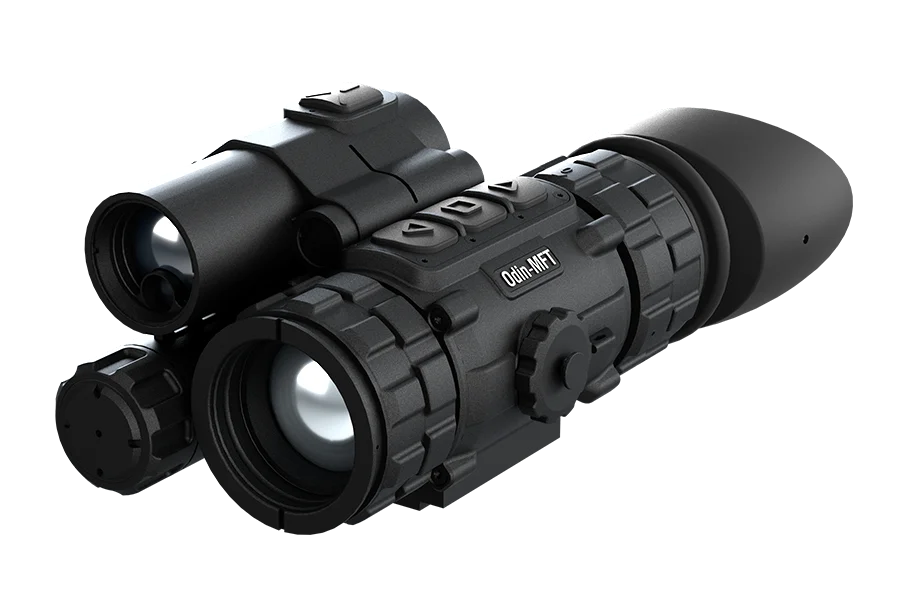 Black tactical rifle scope with multiple adjustment dials and mounted accessories, shown in a close-up view at an angle